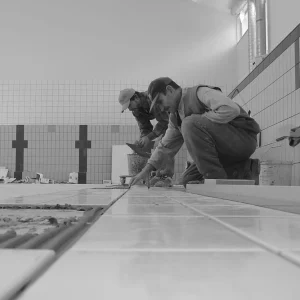 Professional workers tiling a bathroom interior, showcasing expertise in construction.